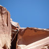 Matt, having just drilled a bolt above his head, takes a look at the wide crack above the roof.