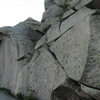 Looking up at the final pitch.  The flake that leads to the corner is visible as the whitish streak leading up and slightly right from the slab, to the left of the obvious left-leaning crack.