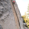 Jesse Groves climbs through the crux of Tobin's Dihedral, Dome Rock.