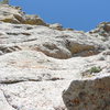 Photo taken from the belay at the top of our Pitch 5.  Pitch 6 trends rightward and then turns up before reaching the outcrop of rocks against the sky in the upper right of the photo.