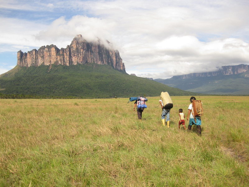 Porters and guides leading us on the approach.  Araguato King ascends the left skyline.  The woman's backpack was made entirely of natural materials - sticks and plant material that the locals use for rope.