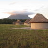 Adobe and thatch houses in Yunek, with another Tepui behind it.  That entire Tepui has maybe 2 routes on it.