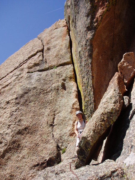 Laura at the end of the second pitch ledge. The wide crack behind her leads to a short rappel to continue on to the summit.