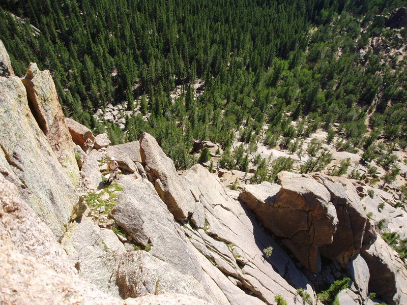 Looking down from the final pitch. The shaded boulder is the rock you do the short rappel from.