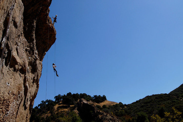 The Planet of the Apes Wall, with a local school group rappelling from the summit.