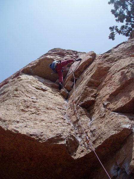 Pulling around the crux roof. Photo by Paul Rezucha.