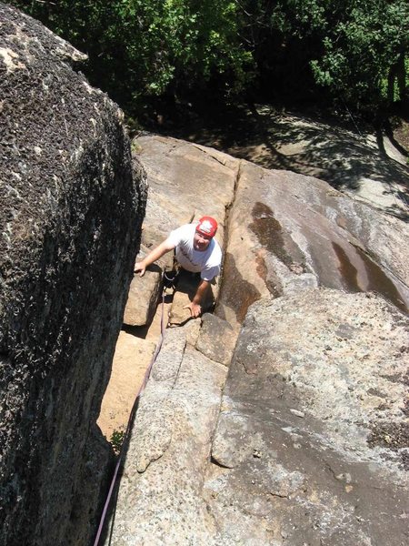 Todd Paris contemplates the awkward second crux top-out of <em>Second Job</em>.