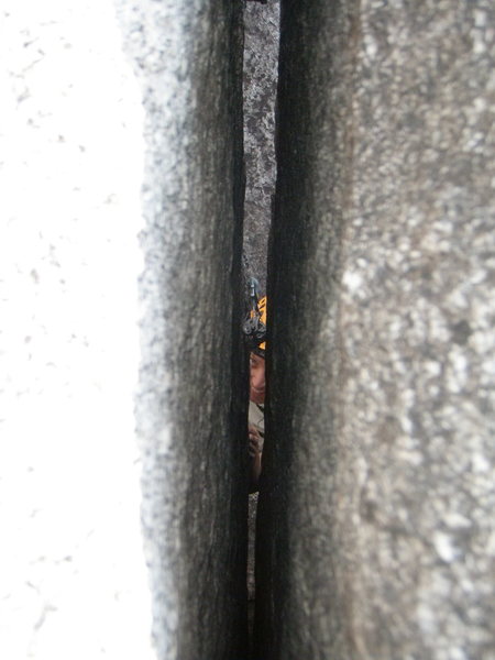 Looking down through the crack from the belay.