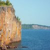 Climbing at Palisade Head with Shovel Point in the background. Poseidon Adventure, Henning Boldt and Kate Muehling. Sept 08, '09.