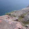 the top-out/top-rope anchor location is located just to the right/south of the stone lookout wall (you can see it in the left-hand side of the photo).