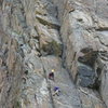 Amanda Moyer belaying Ken Jern on Monkeyflower. The crux second pitch of Triple Roofs can be seen above and slightly right of Moyer. 