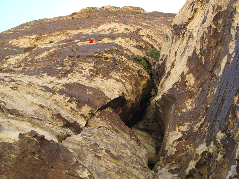 Pitch 6 ends on the face after the leftward traverse. One bolt was missing from the anchor. I built a trad anchor in the crack below the bolt.