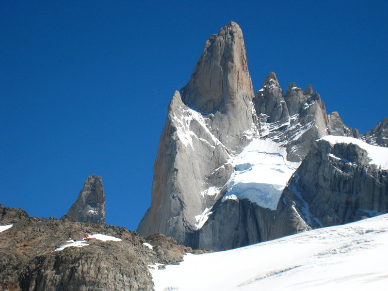 The East Face of Poincenot. The Whillans Route follows the obvious snow ramp to the shoulder between the East & South faces. The upper, rock section is around the corner to the left on the upper South face.