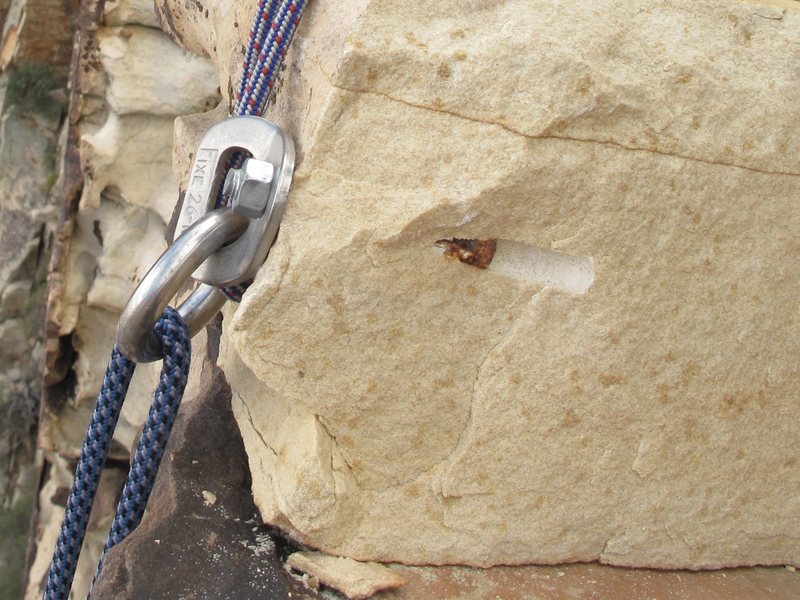 The rock has broken away from one of the bolts from the top rappel anchor.