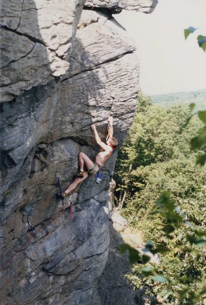 J. Healy setting the last piece of pro on 'The Wizard', circa 1986. From there, you swing around the arete and top out on the other side under the hanging block.