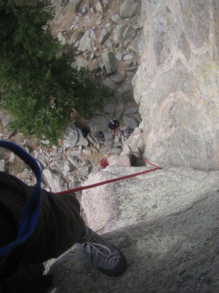 Looking down at belayer from halfway up Malign.