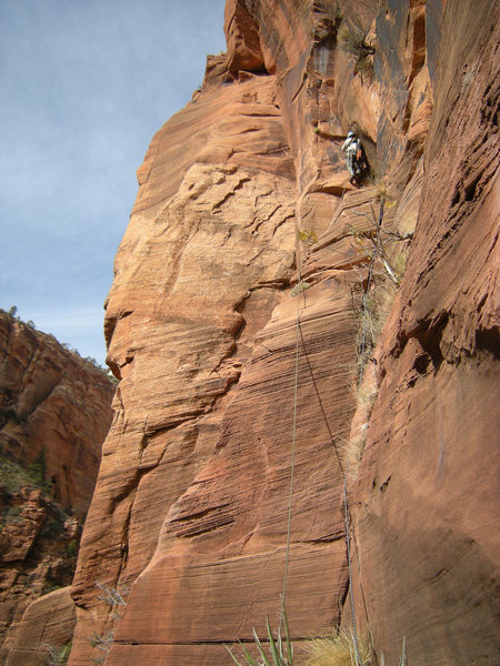 Pitch 5, steep climbing above a short tension traverse.