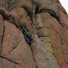 Avoiding the "crux". Stepping left to the chains of the Great White Crime.  Makes a great warm up 5.8 pitch.