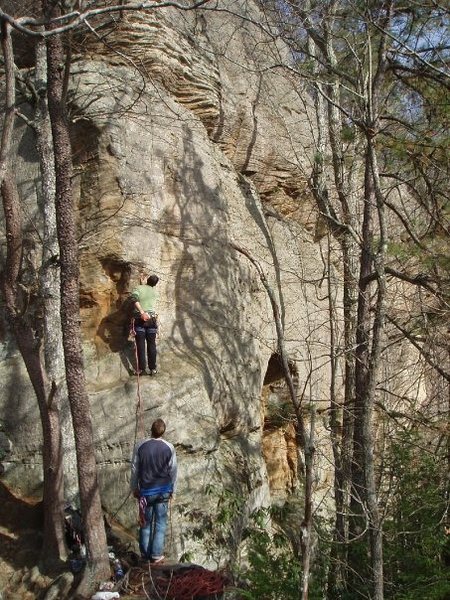 A. Rothman preparing to tackle Captain One Eye. Belayer is protected with cam in crack in front of him.