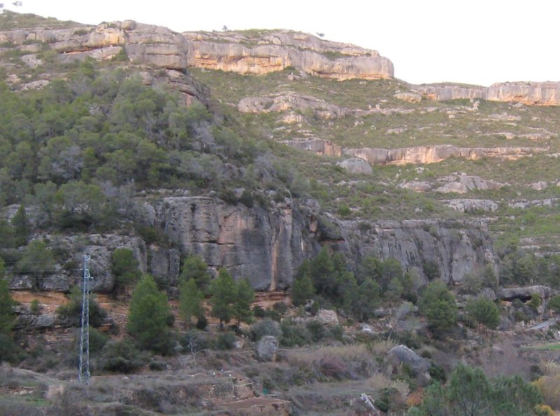 Can Torxa is the lower large gray cliff.