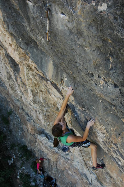 Page cranking through the steep start of a 5.12a near the left end of the cliff. The route is A View to a Kill.