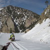 Getting towed by a snowmobile on my snowboard towards the crag.