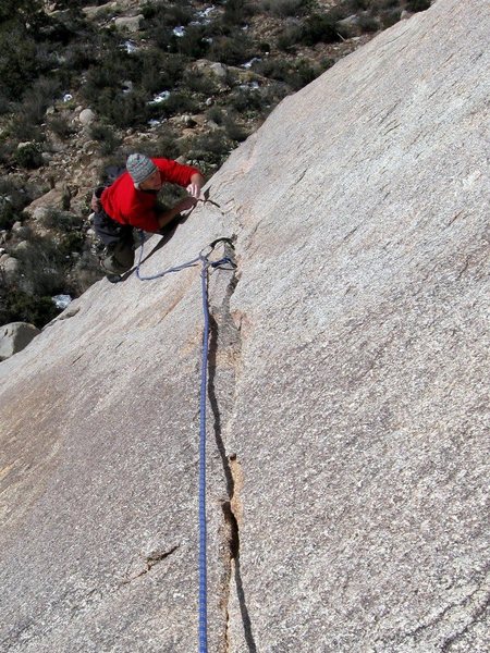 Luke following the sweet arching finger crack of Reunion on Granite Mountain's Flying Buttress.