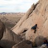 Stretched out at the crux of Bulletproof (5.11d), Joshua Tree NP<br>
