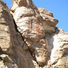 David Merin beginning the traverse across the horizontal crack - leaving Hashbrowns and entering the business on Flame Out. <br>
<br>
Photo by Eric Rhicard