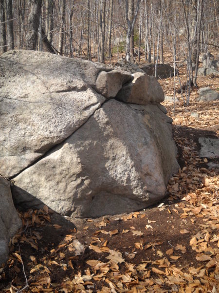 Sit start with feet on the left boulder then swing the hips and feet to the big boulder and reach for the slopper 