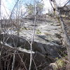 The short central ledge is 'Dystonia' and above right of it, the over lap section nearly to top of first pitch of Hannah. The dark section below this slab is where Lost in Utopia begins