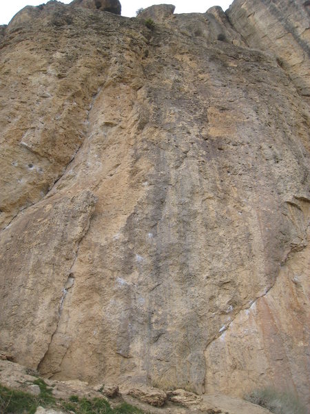 Sun Spot climbs the gray face between the detached flake and the undercling crack.