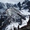 Zowie in the foreground. From left to right, Cathedral Wall, The Saber, Sharkstooth, and Mount Taylor. The Vanquished Buttress and Powell Peak are visible in the background.