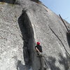 Bryce starting Happy Face.  Good Astro brass nut protects getting to the first bolt.  Beautiful mid March day with just a little snow at the base way up here on the West side.