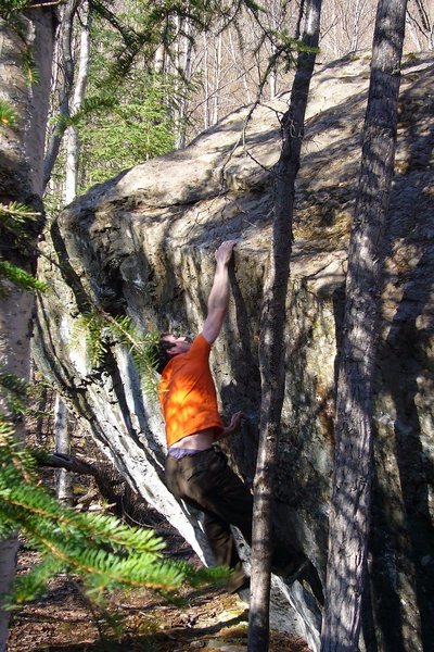 Tom Scupp sticking the crux lunge on Finger on the Trigger.