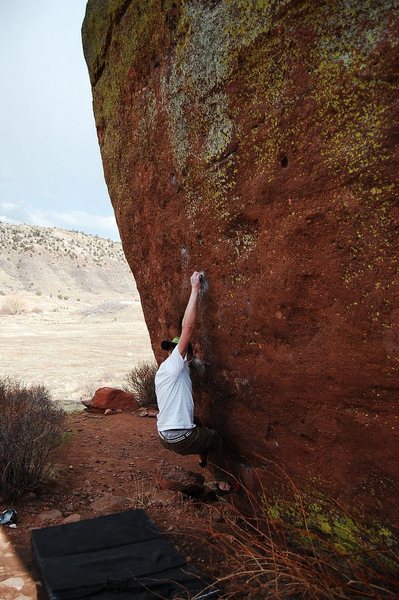 Jared LaVacque, enjoying a break between storms, on Ghost Dance V7,  Matthew Winters Park, CO.