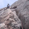 Getting to the business on Pitch One. Getting into and then out of the stem up and left is probably the crux of this sustained pitch. (Photo by Chuck Graves.)