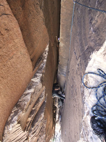 The last moves before the first 5.9 chimney belay (leaders note that the belay is behind and climber's right as you are facing toward the chimney)