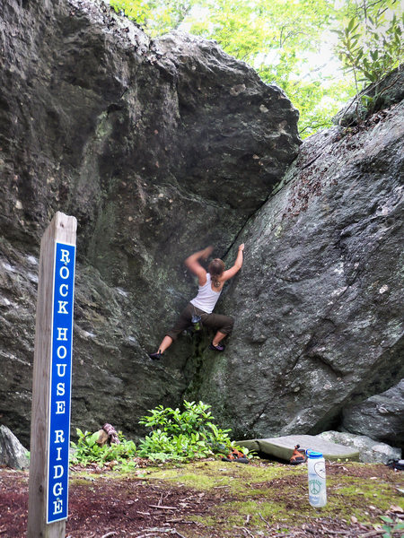 kasi Quinn on "Cherokee Dihedral" (V-1), Rock House Boulder, Grayson Highlands State Park