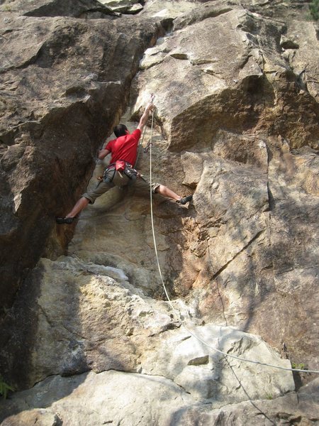Clipping the second bolt on Justice before moving into the crux.