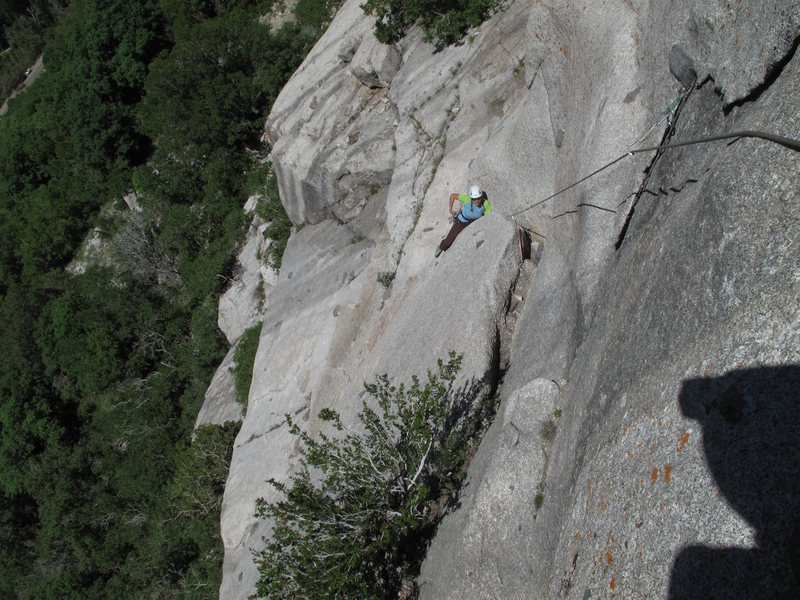 Maura emerging from the steep offwidth bulge, with the nice thin flake above.