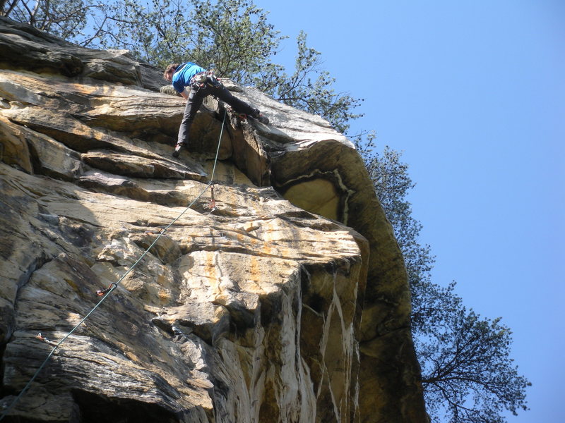 Surmounting the the roof in the final feet of this fun and varied route.