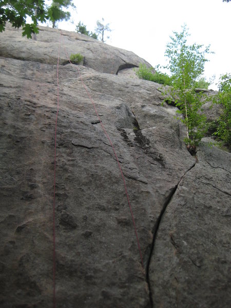 Not the best picture... Half Moon Crack starts in the right angling crack below and up onto a ledge.  Continue up the half moon crack and decent edges to the top.