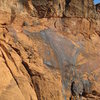 This picture gives a sense of the scale of the route. The toprope that can be seen to the left of the climber is on a different route (Heaven's a lie, 5.11c).