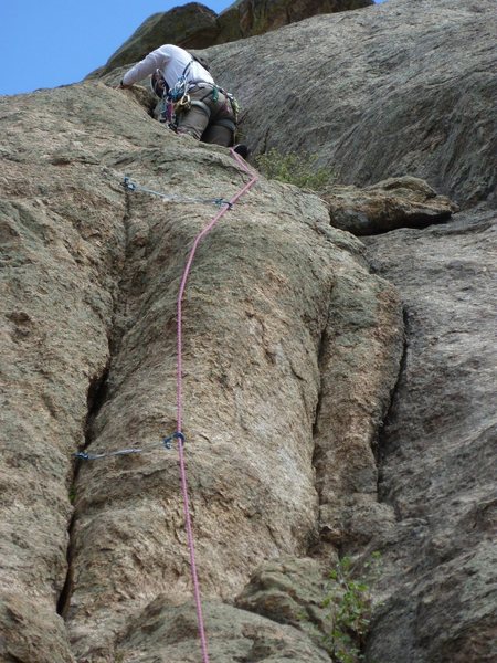 Margaret leading right after the P1 crux and the fixed ring piton.  When I lead it, I could reach with my 35" arms to the right and place a cam.  Don't know what the protectable crack to the right goes at.