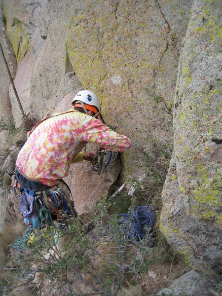 Aaron replacing webbing at the first rap anchor on the South Face Direct.