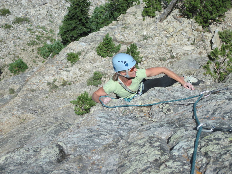 Becky Hall turning the "Gunks-like roof" on the headwall.<br>
<br>
(Photo: Charley Mace.)