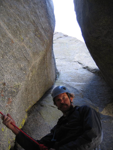 Belaying under the chockstone. This final pitch behind Jay is obvious and an excellent finish. It is probably the original end to the climb. 