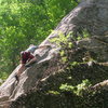 Chris Graham moving up to the undercling. AP Treat, Cathedral Ledge. North Conway. Photo by Jeff Lea