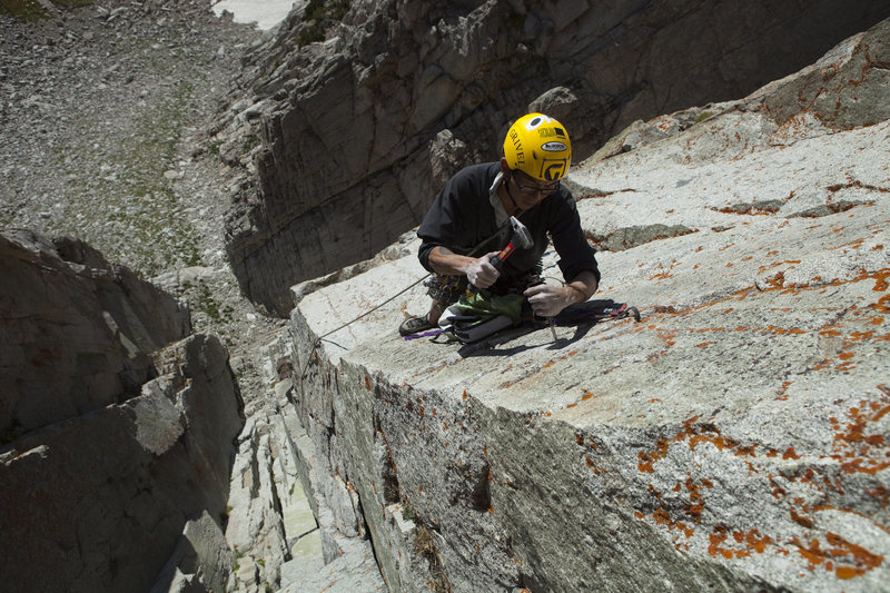 Drilling the lone bolt on P3 during the FA.  Photo, courtesy Andrew Burr Photography, 2009.